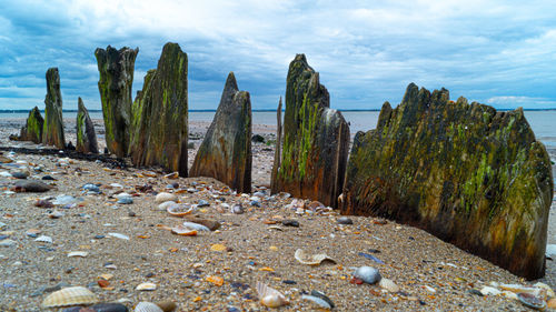 Panoramic shot of rocks on field against sky