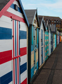 Multi colored houses on footpath amidst buildings in city