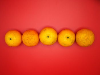 Close-up of fruits against orange background