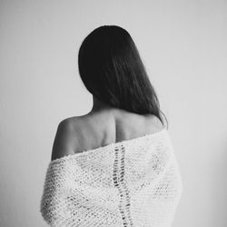 Rear view of woman standing over white background