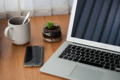 Close-up of wine and laptop on table