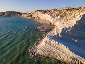 High angle view of rocks on shore against sky