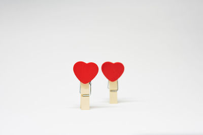 Close-up of red heart shape over white background