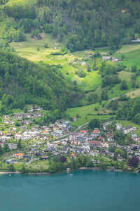 Aerial view of town by river against sky