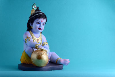 Man sitting against blue wall