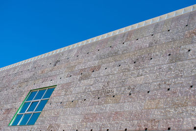 Low angle view of building against clear blue sky