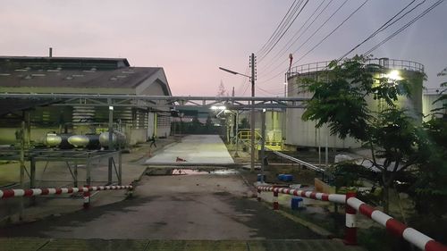 Cars on road against sky in city at dusk