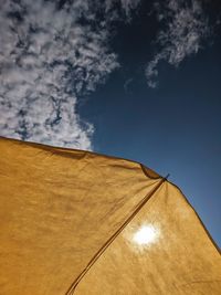 Low angle view of sunshade against sky