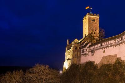 Low angle view of clock tower against sky at night