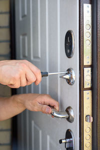 Close-up of man working on door