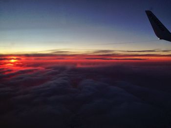 Cropped image of airplane flying over clouds