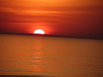 Scenic view of sea against orange sky