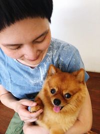 Portrait of cute girl holding dog