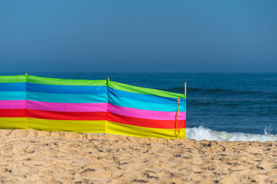 Beach screen on the polish beach on a sunny summer day in the background beautiful sea.