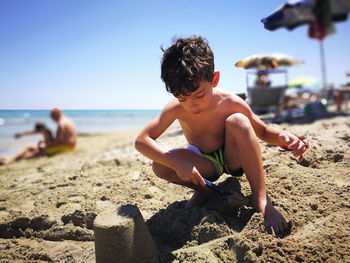 Shirtless boy on beach