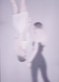 Blurred motion of woman standing against white background