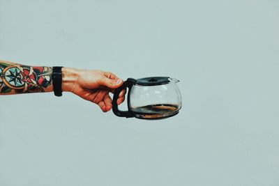 Close-up of man holding tea kettle