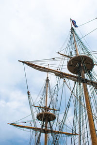 Low angle view of sailboat sailing on ship against sky