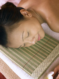 Close-up of woman lying on table at spa