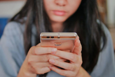 Midsection of woman using mobile phone