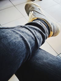 Low section of man wearing shoes