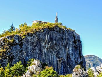 Panoramic view of castle by mountain against clear sky