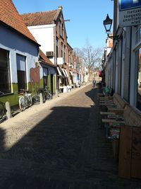 Street amidst houses and buildings against sky