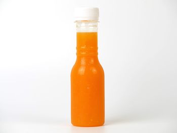 Close-up of glass bottle against white background