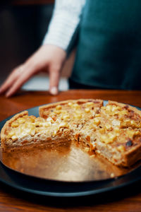 Close-up of hand in plate on table