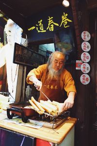 Portrait of woman standing by food