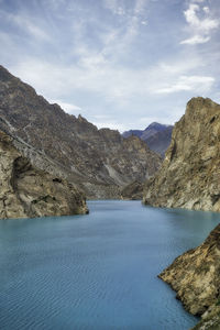 Scenic view of river amidst mountains against sky