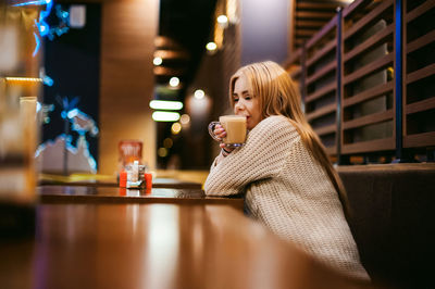 Woman having drink in restaurant