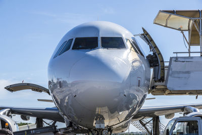 Close-up of airplane against clear blue sky