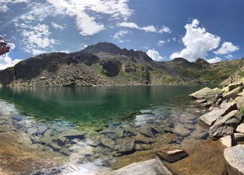 Scenic view of lake and mountains against sky