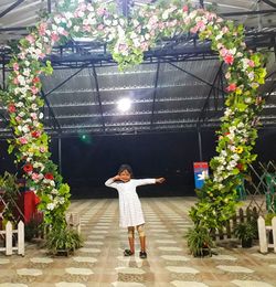 Rear view of woman standing by potted plants