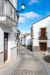 Street amidst buildings in city against sky