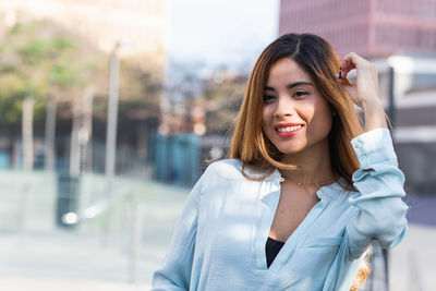 Portrait of smiling woman standing outdoors