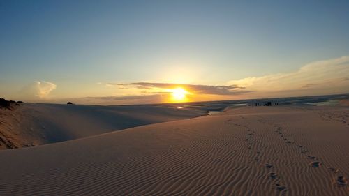 Scenic view of land against sky during sunset