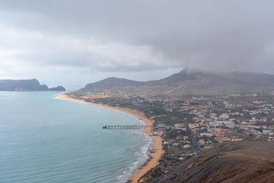 High angle view of sea and city against sky