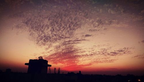 Silhouette built structures at sunset