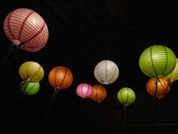 Low angle view of illuminated lanterns in the dark