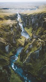 Aerial view of stream amidst mountains