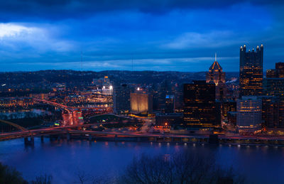 Illuminated buildings in city at dusk