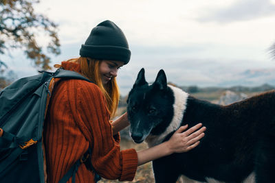 Midsection of person with horse in winter