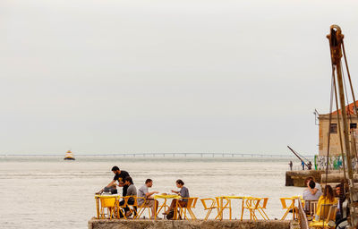 People on beach against sky