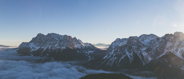 Panoramic view of snowcapped mountains against clear sky during winter