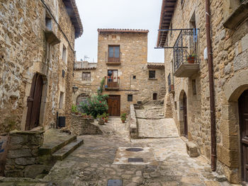 Alley amidst old buildings in town