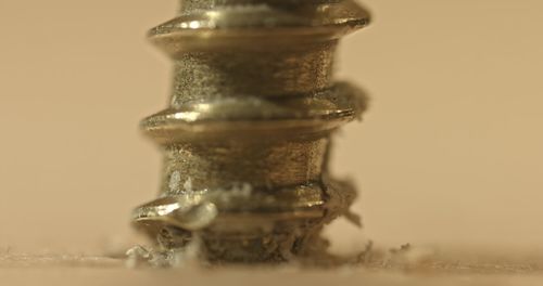 Close-up of glass jar on table against white background