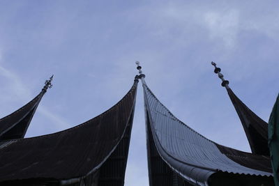 Low angle view of bridge and buildings against sky