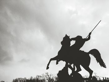 Low angle view of statue against cloudy sky